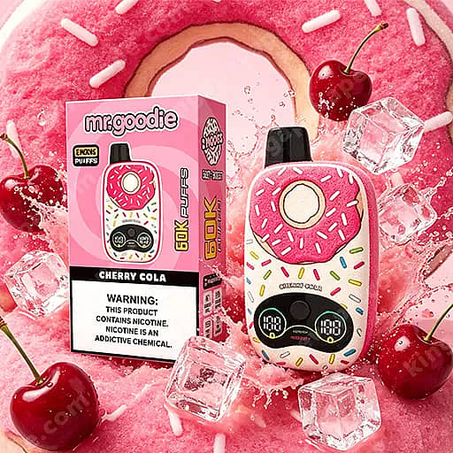 A Pink, Donut-Shaped Vape Device With White Sprinkles And A Cherry On Top Sits Beside A Matching Pink Box Labeled Mr.goodie Cherry Cola, Set On A Bright Pink Background With Ice Cubes And Cherries.