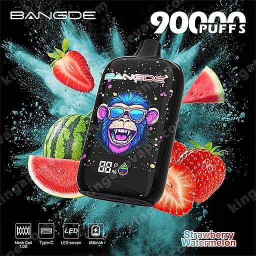 Bang De 90000 Puffs Disposable Vape | Smart Led Screen &Amp; Mesh Coil 14 A Bangde Compact Vape Device With A Blue Cartoon Monkey On The Screen Sits Among Watermelon And Strawberry Slices Against A Teal Splash Background, Advertising 9000 Puffs And The Strawberry Watermelon Flavor.